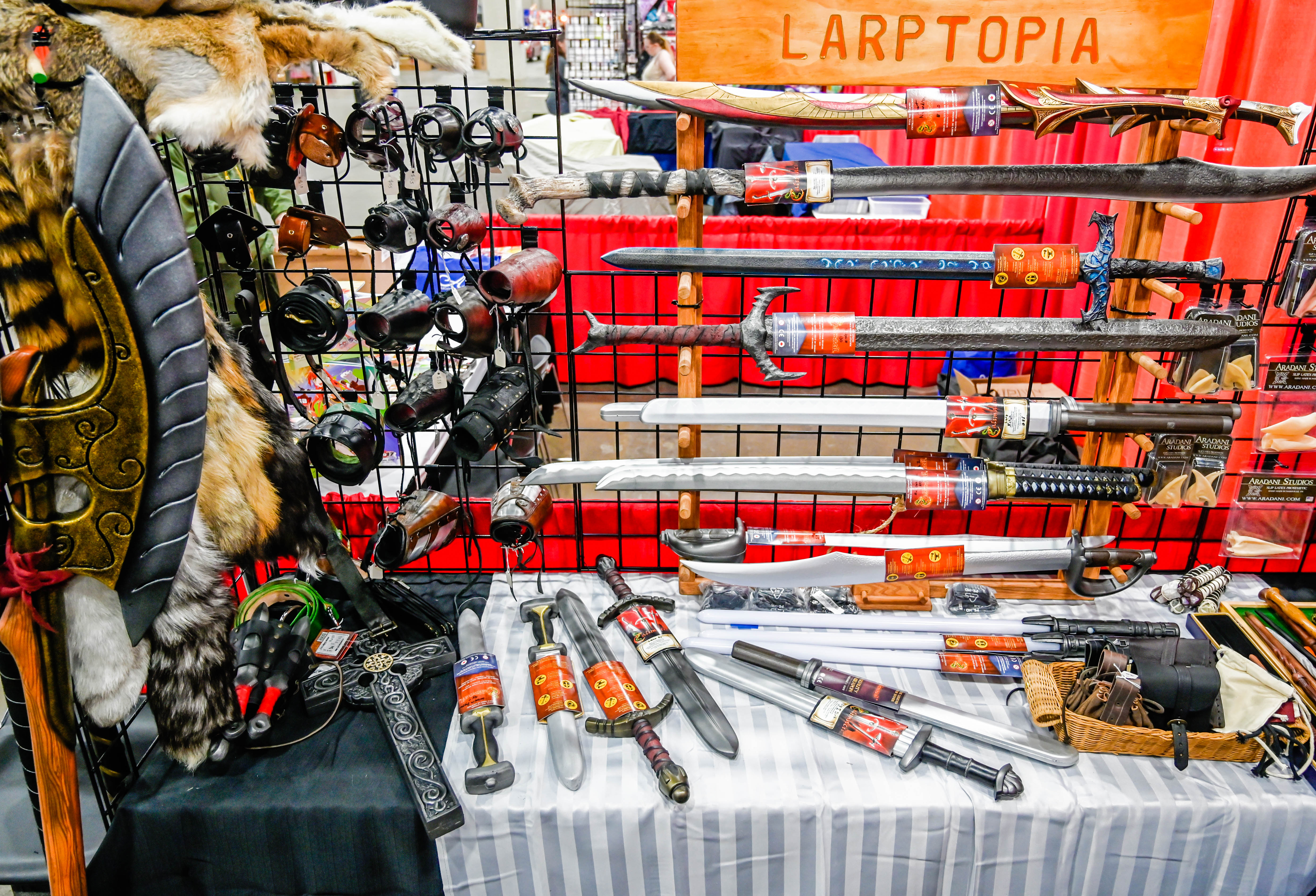 larptopia weapons and wares at youmacon 2019 with leather bracers, sword frogs, calimacil daggers, epic armoury axe, and fur tails