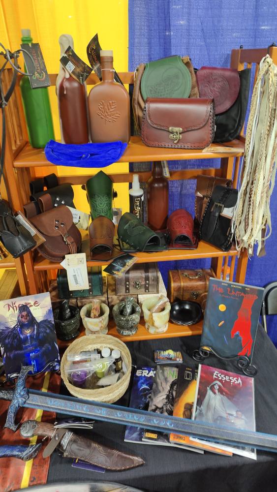 motor city comicon larptopia booth, stranger comics, geralt hunting knife, niobe sword, leather pouch, leather bracers, foam bottles, morter and pestal, pen ink, hair tassels